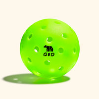 A bright green pickleball with the logo 'GSI' printed on it, featuring numerous holes typical of a pickleball.